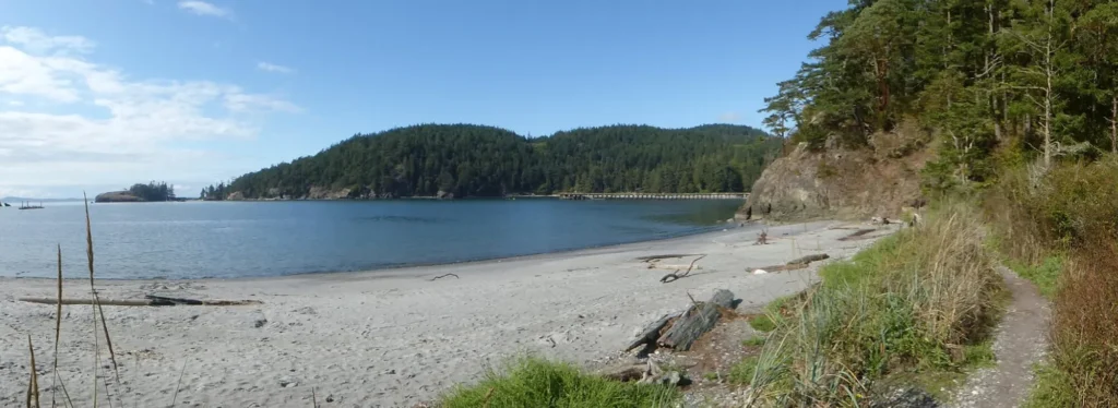 Sandy beach and coastal trail at Bowman Bay in Deception Pass State Park near Anacortes, Washington.